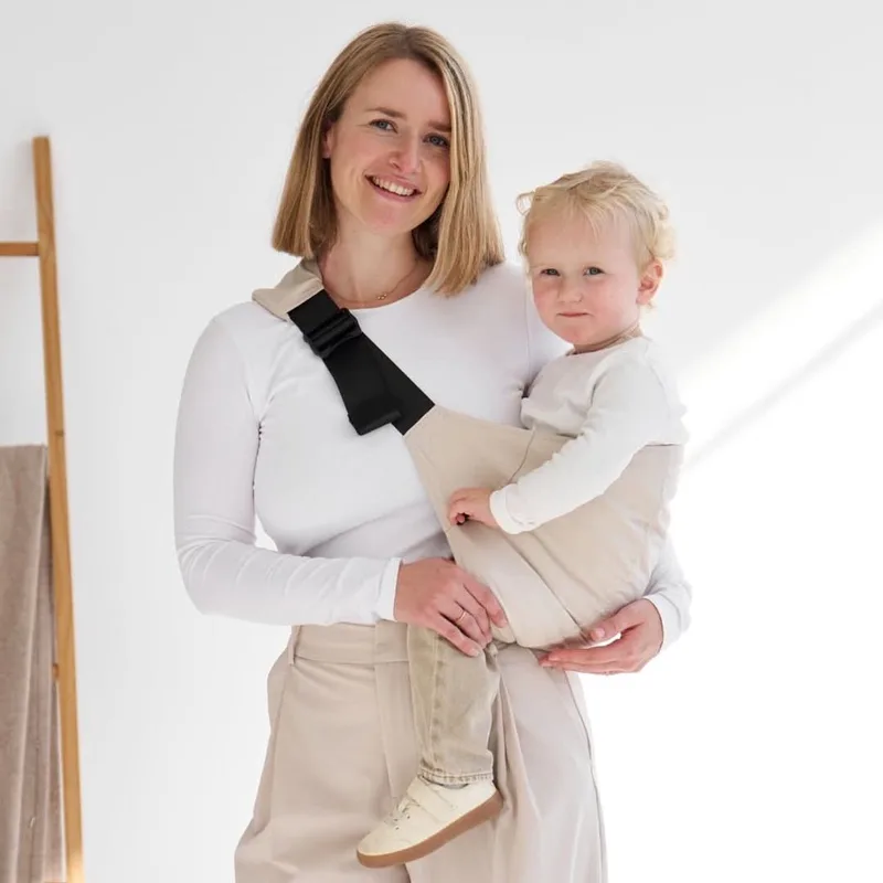 Heupdrager Baby I Ergonomisch & rugsparend I Snel om te doen – Drager vanaf 9 maanden tot ca. 4 jaar I Zijdrager voor peuters I Ideaal voor onderweg I Babydrager heupzitje de Rookie en Beige – photo produit